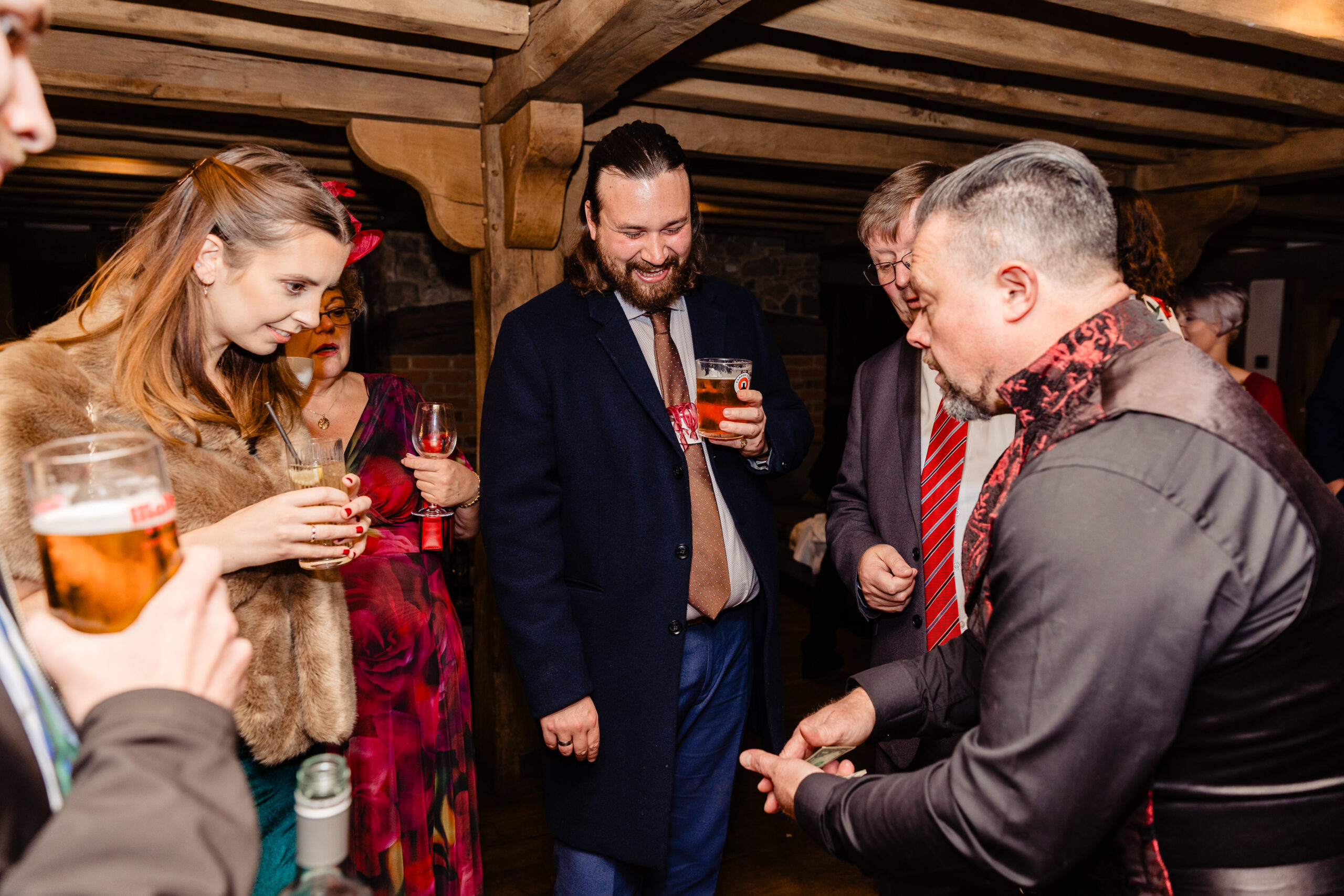 David Hitchcott performing close-up magic surrounded by wedding guests